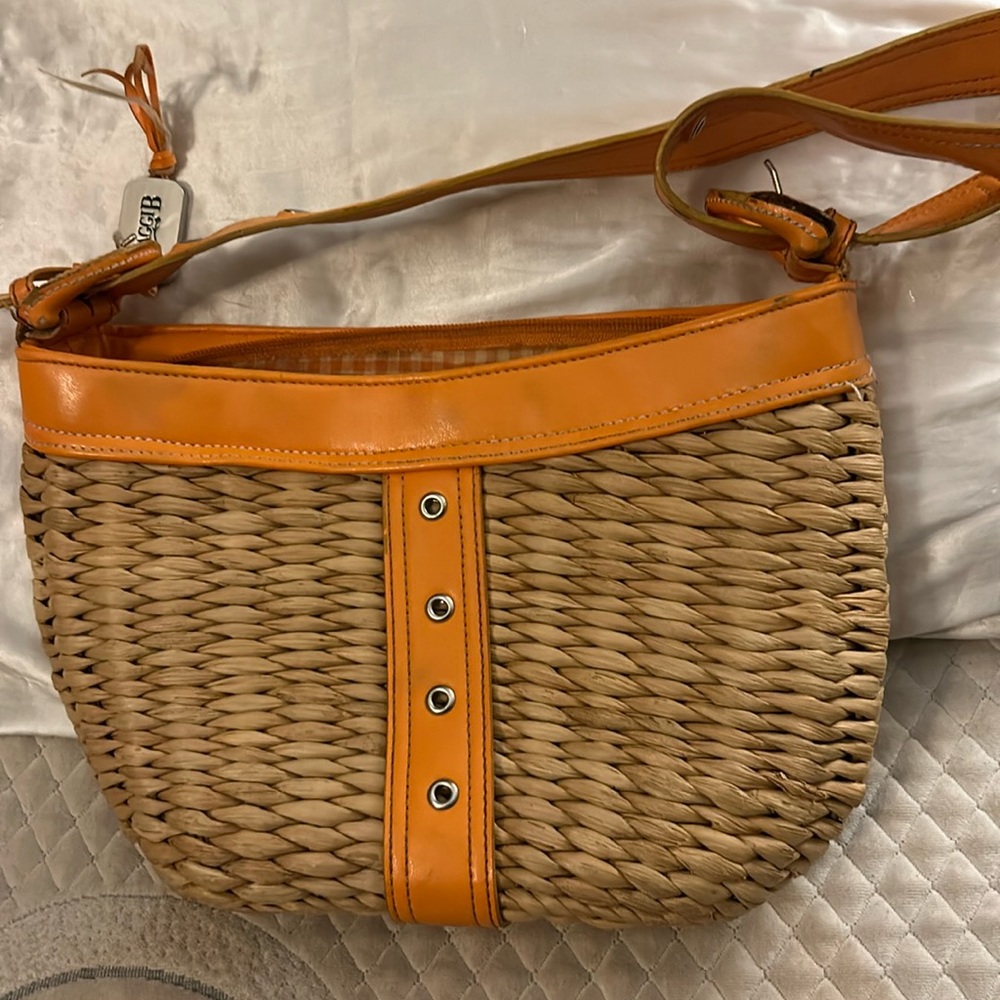 Adorable small straw purse with orange trim.